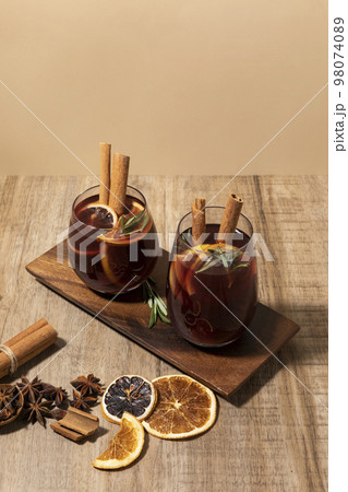 Christmas drink Vin Chaud, French mulled wine ingredients_cinnamon and dried fruits Christmas drink Vin Chaud, French mulled wine ingredients_cinnamon and dried fruits 98074089