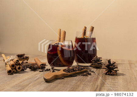 Christmas drink Vin Chaud, French mulled wine ingredients_cinnamon and dried fruits Christmas drink Vin Chaud, French mulled wine ingredients_cinnamon and dried fruits 98074132