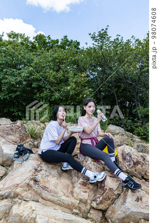 korean young women hiking and plogging_eating water and lunch box korean young women hiking and plogging_eating water and lunch box 98074608