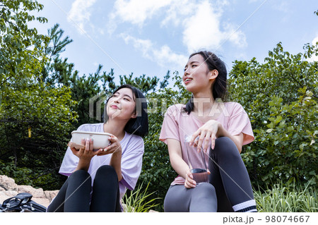 korean young women hiking and plogging_eating water and lunch box korean young women hiking and plogging_eating water and lunch box 98074667