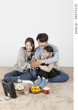 happy Asian Korean family, isolated in white background_warm oneself at a stove 98075230