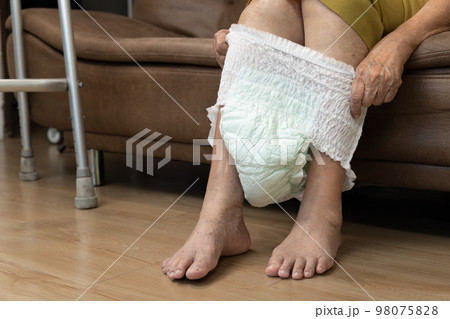 Urinary Incontinence in elderly and changing diaper. Urinary Incontinence in elderly and changing diaper. 98075828