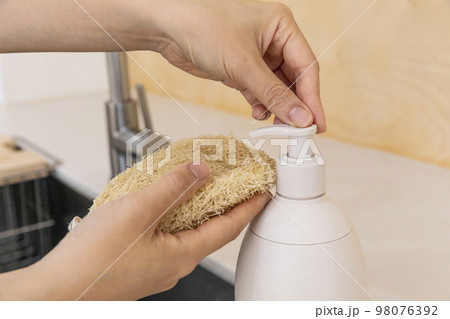 eco friendly habits hand gesture_using eco friendly sponge and detergent 98076392