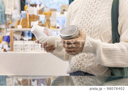 eco friendly habits hand gesture_holding a refill bottle 98076402