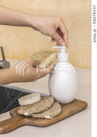 eco friendly habits hand gesture_using eco friendly sponge and detergent 98076437