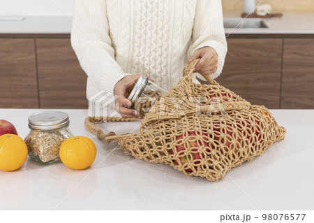 eco friendly habits hand gesture_taking out the ingredients from the shopping cart 98076577