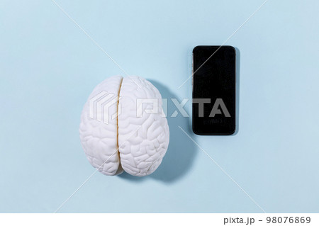brain health and dementia series_a brain miniature and cell phone brain health and dementia series_a brain miniature and cell phone 98076869