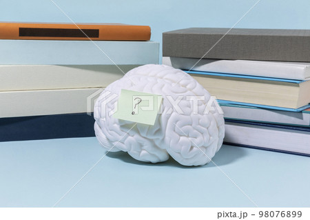 brain health and dementia series_stacked books and brain miniature brain health and dementia series_stacked books and brain miniature 98076899