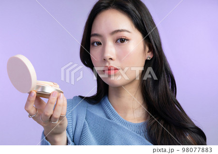 beautiful young Korean Asian woman portrait studio photo in winter skin beauty and cosmetics concept__holding foundation beautiful young Korean Asian woman portrait studio photo in winter skin beauty and cosmetics concept__holding foundation 98077883
