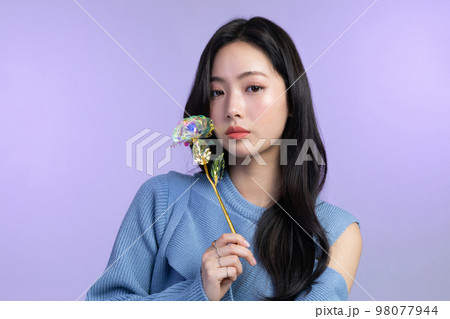 beautiful young Korean Asian woman portrait studio photo in winter skin beauty and cosmetics concept__holding a flower beautiful young Korean Asian woman portrait studio photo in winter skin beauty and cosmetics concept__holding a flower 98077944