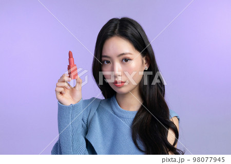 beautiful young Korean Asian woman portrait studio photo in winter skin beauty and cosmetics concept__holding a lipstick beautiful young Korean Asian woman portrait studio photo in winter skin beauty and cosmetics concept__holding a lipstick 98077945
