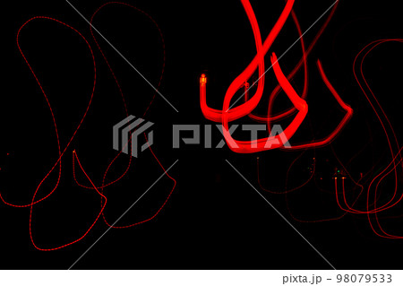 Long exposure, light painting photography, multi color swirl effect against black background. Night city lights  98079533