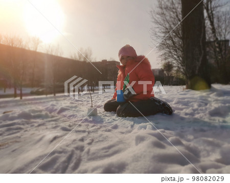little girl playing in the snow on a city street. little girl playing in the snow on a city street. 98082029