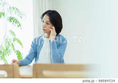 リビングで考え事をするミドル女性 リビングで考え事をするミドル女性 98084534