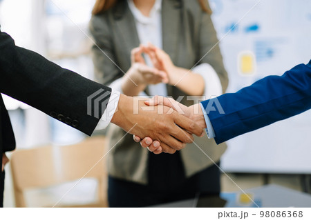 wo confident business man shaking hands during a meeting in the office, success, dealing, greeting and partner wo confident business man shaking hands during a meeting in the office, success, dealing, greeting and partner 98086368