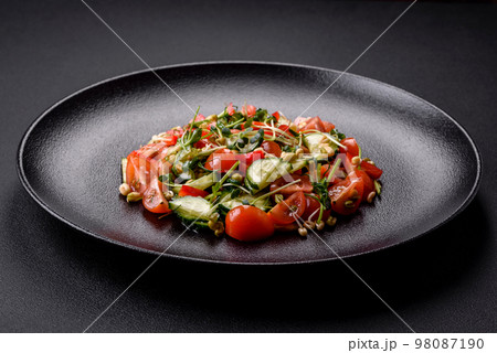 Delicious juicy fresh salad of tomatoes, peppers, cucumber, microgreens and sprouted  mung bean 98087190