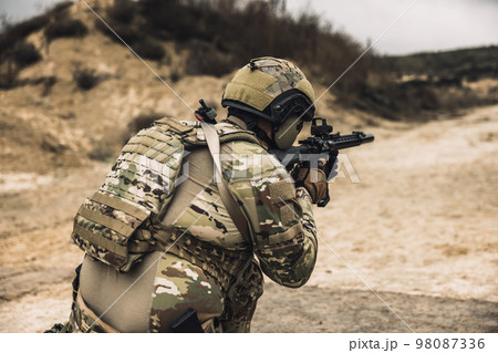 Sniper with rifle on a position 98087336