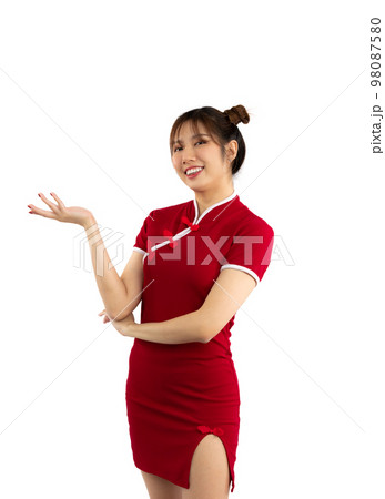 Smiling young asian woman in red traditional chinese dress holding red paper lantern on red background. Chinese New Year concept. Smiling young asian woman in red traditional chinese dress holding red paper lantern on red background. Chinese New Year concept. 98087580