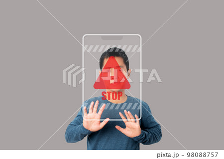 Young man showing stop gesture with stop sign virtual screen. Young man showing stop gesture with stop sign virtual screen. 98088757