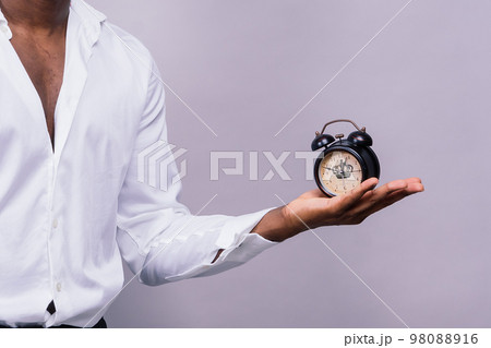 Time Management Concept. Shocked black man holding wall clock, running out of time. Time Management Concept. Shocked black man holding wall clock, running out of time. 98088916