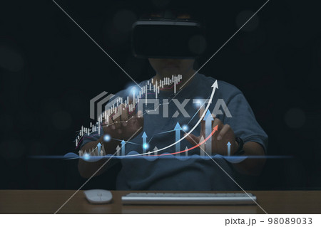 Man wearing VR Headset trading graph financial data, Stock Market Investments analysis and Digital Assets. Man wearing VR Headset trading graph financial data, Stock Market Investments analysis and Digital Assets. 98089033