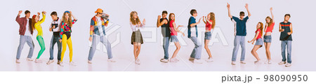 Group of young, cheerful people wearing 80s, 90s fashion style clothes dancing isolated over grey background. Disco party. Concept of youth, retro style, 90s era, fashion, lifestyle, ad 98090950