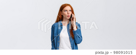 You say what. Intense and frustrated, confused redhead woman getting tensed and distressed hearing some bad news on phone, calling friend realise something awful happened, white background You say what. Intense and frustrated, confused redhead woman getting tensed and distressed hearing some bad news on phone, calling friend realise something awful happened, white background 98091015