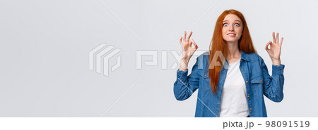 Excited and happy fascinated redhead woman looking pleased and astonished, visit awesome favorite movie, showing okay gesture, review amazing party, smiling and staring thrilled Excited and happy fascinated redhead woman looking pleased and astonished, visit awesome favorite movie, showing okay gesture, review amazing party, smiling and staring thrilled 98091519