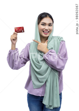 Asian Muslim woman in a headscarf showing a credit card 98092087