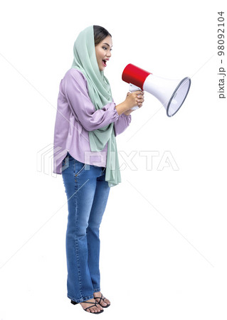 Asian Muslim woman in a headscarf yelling on a megaphone 98092104