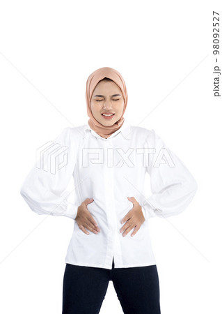 Asian Muslim woman in a headscarf feeling stomachache 98092527