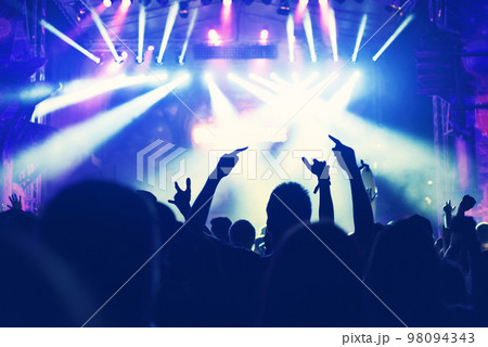 Crowd with arms outstretched at concert 98094343