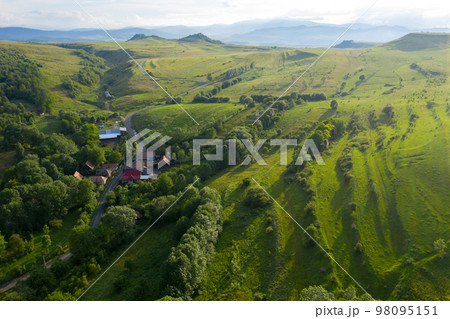 Flying over a village in Transylvania, Romania by drone Flying over a village in Transylvania, Romania by drone 98095151