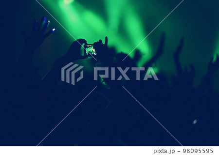 Crowd with arms outstretched at concert Crowd with arms outstretched at concert 98095595