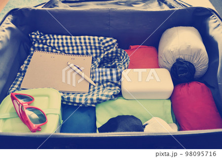 Travel accessories in a suitcase. Vintage toned Travel accessories in a suitcase. Vintage toned 98095716