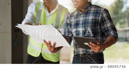 Professional architect designer structural engineer team colleagues discussing building plan design project 98095736