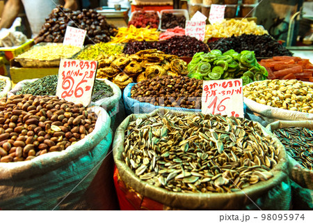 Heap of nuts and sunflower seeds, pistachio in bags 98095974