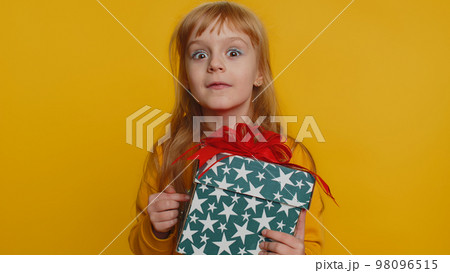 Lovely smiling preteen child girl kid presenting birthday gift box offer wrapped present celebrating 98096515