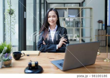 Portrait of a Asian woman lawyer studying a lawsuit for a client before going to court. Portrait of a Asian woman lawyer studying a lawsuit for a client before going to court. 98100186