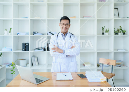 doctor looking at a patient's information before treating a disease. 98100260