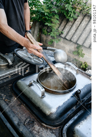 A man prepares lunch in a military field kitchen. 98101147