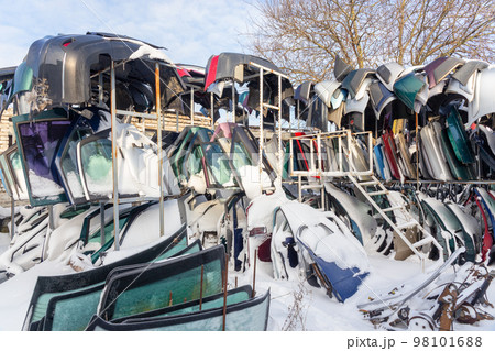 Disassembled cars on a car dump are on sale for spare parts. Disassembled cars on a car dump are on sale for spare parts. 98101688