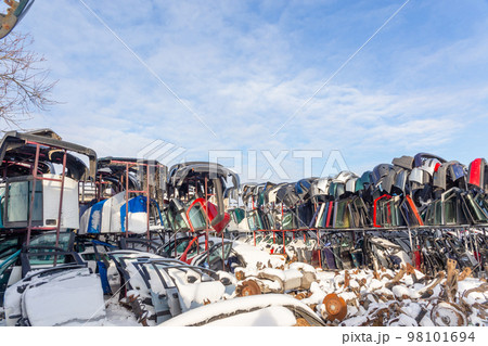 Disassembled cars on a car dump are on sale for spare parts. Disassembled cars on a car dump are on sale for spare parts. 98101694