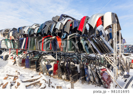 Disassembled cars on a car dump are on sale for spare parts. Disassembled cars on a car dump are on sale for spare parts. 98101695