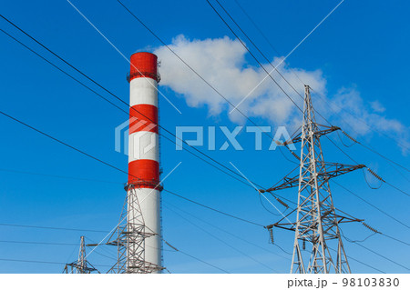 The pipe of the industrial plant emits toxic smoke into the atmosphere and air. Pollution of the environment and ecology. Thermal power plant power lines high voltage 98103830