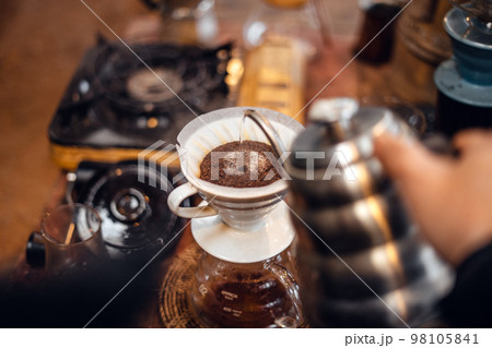 Closeup of hands barista make coffee Closeup of hands barista make coffee 98105841
