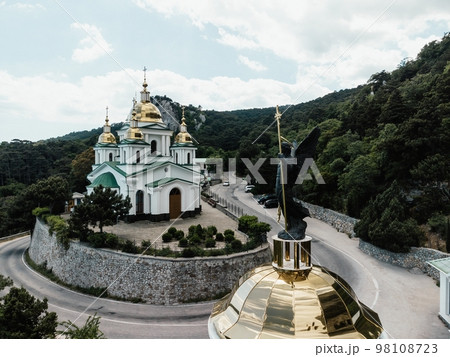 Christian church in the mountains above the sea. Temple of the Holy Archangel Michael in Oreanda. The southern coast of Crimea. Aerial view Christian church in the mountains above the sea. Temple of the Holy Archangel Michael in Oreanda. The southern coast of Crimea. Aerial view 98108723