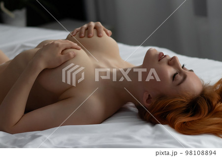 Sensual ginger woman in underwear on bed Sensual ginger woman in underwear on bed 98108894