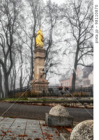 Marian column Immaculata in foggy park in city Ruzomberok, Slovakia Marian column Immaculata in foggy park in city Ruzomberok, Slovakia 98110870