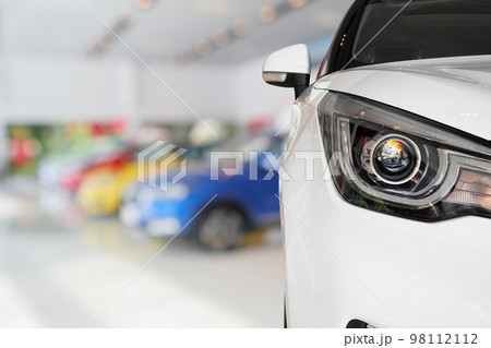 closeup front of new car in showroom background closeup front of new car in showroom background 98112112